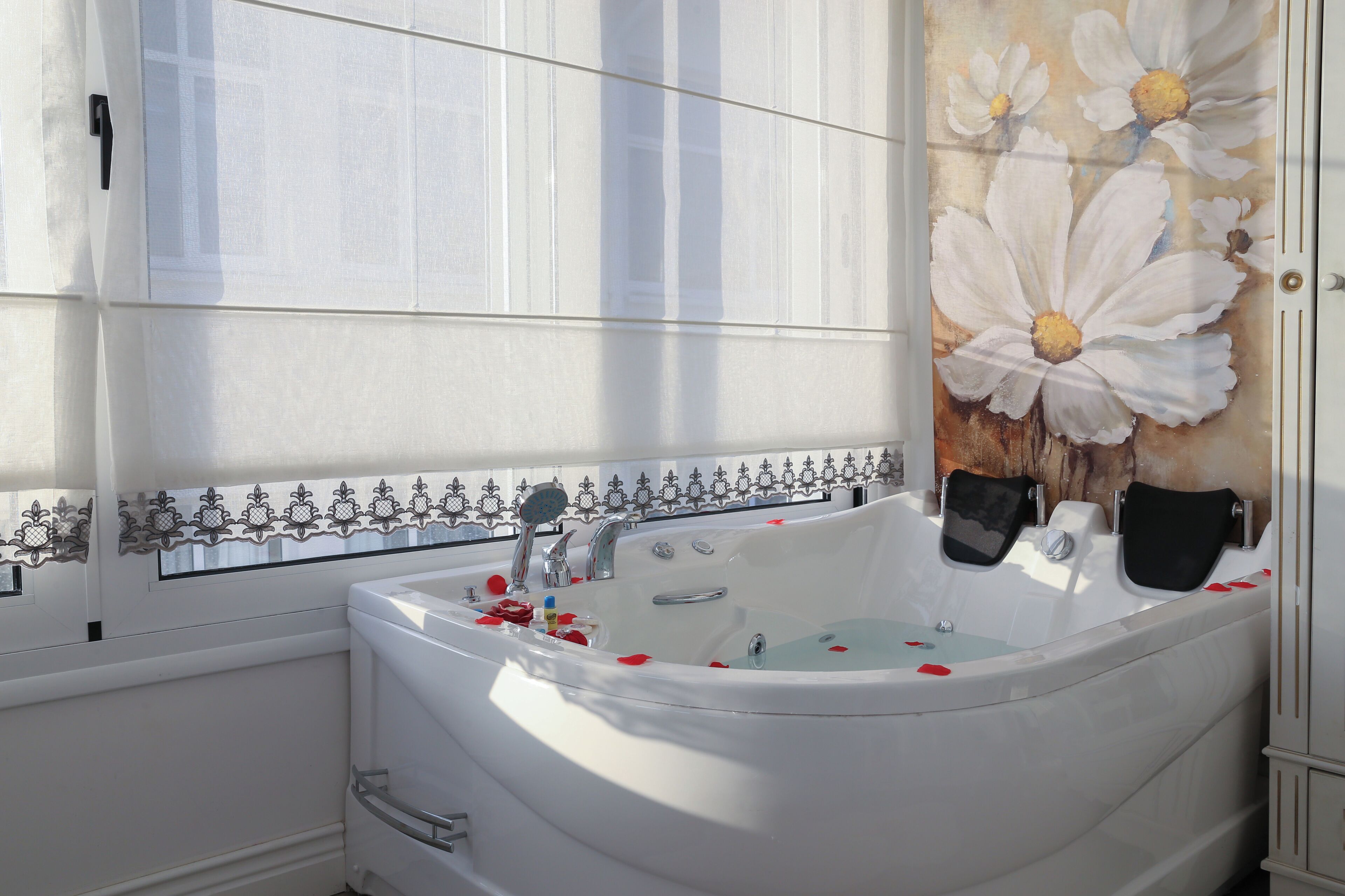 A bathroom with a large bathtub, a toilet, and a shower.
