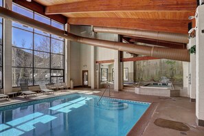 Relax by the pool surrounded by lounge chairs and a hot tub.