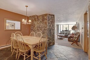 Enjoy a comfortable living area with a dining table, sofa, and armchairs.