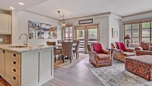A spacious living area with a kitchen, dining table, and seating. - Perfect Passage to Copper Mountain - PP327 by RedAwning (Copper Mountain)
