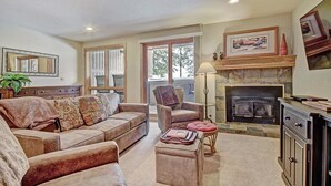 A living room with a fireplace, a sofa set, a chair, and a lamp. - Beautiful Ski-In Ski-Out Condo, Great Location - CM244 by RedAwning (Copper Mountain)