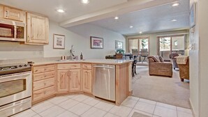 A modern kitchen with wooden cabinets, a built-in oven, and a dishwasher. - Beautiful Ski-In Ski-Out Condo, Great Location - CM244 by RedAwning (Copper Mountain)