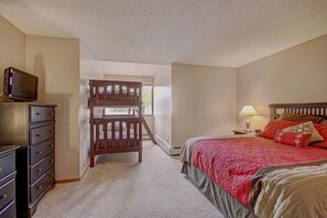 A bedroom with a bed, dresser, and a television on a dresser. - Spacious, Comfortable Retreat at Copper Mountain - VS549 by RedAwning (Copper Mountain)