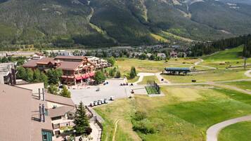 A mountain lodge with a pool, guest rooms, and a ski lift area.
