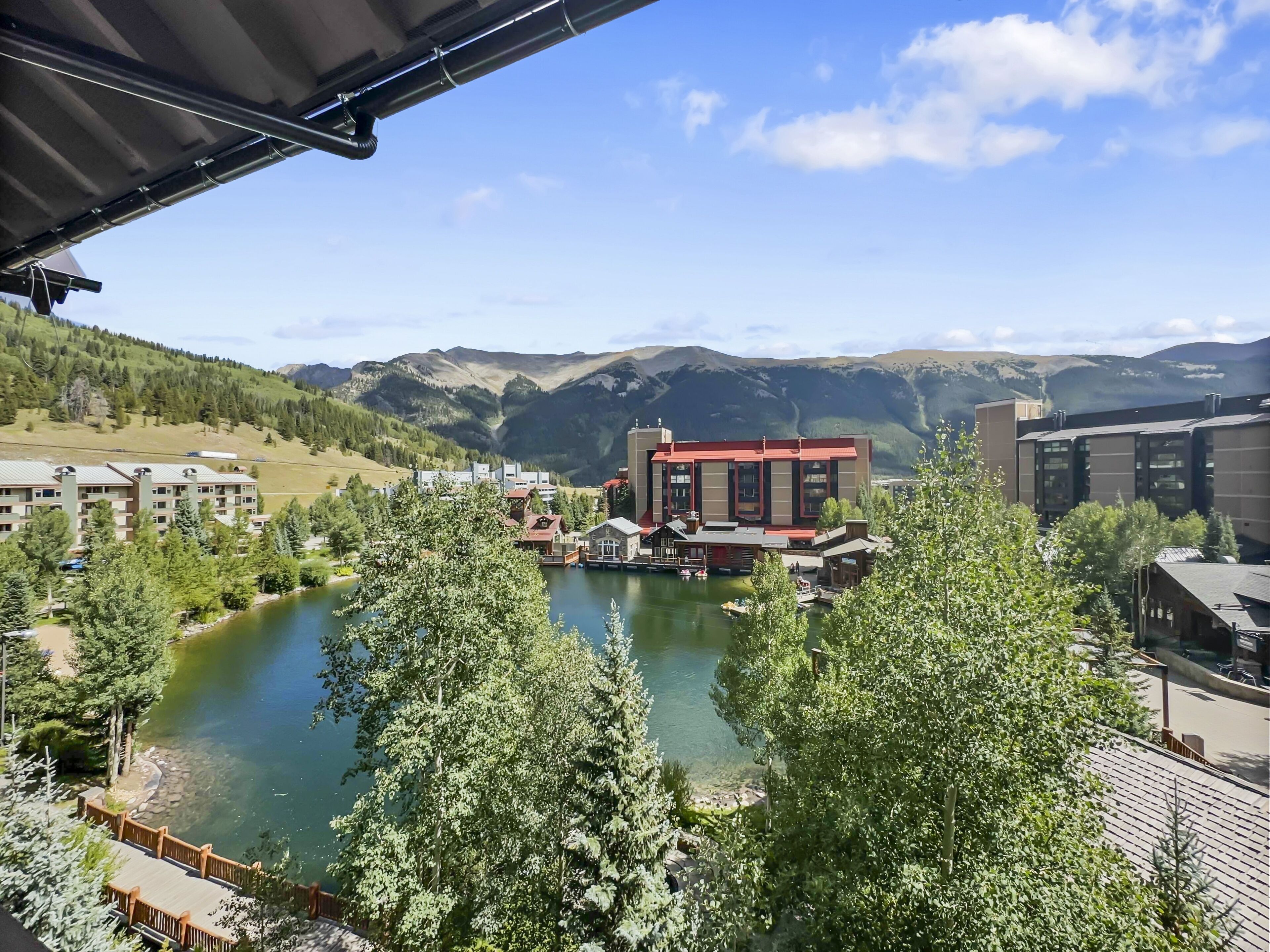 A hotel with a view of a lake and mountains.