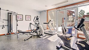A gym with cardio machines, weight training equipment, and a large window providing a view of the outside. - Best Location On The Mountain, Amazing View - CO204 by RedAwning (Copper Mountain)