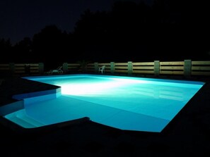 A swimming pool at night with blue lighting. - Hotel Bellevue (Doksy)