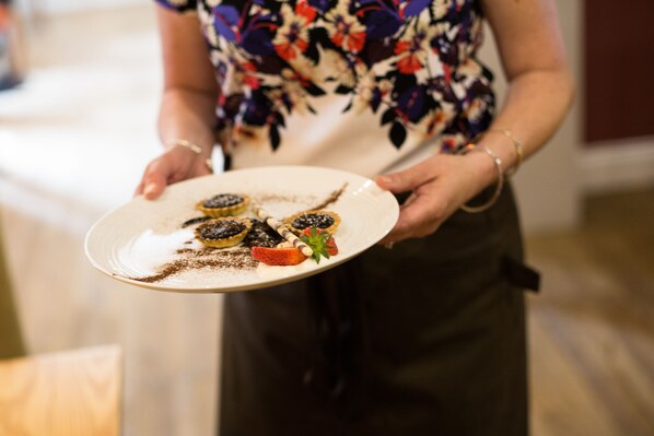 A person holding a plate with food items. - Greenbanks Hotel (Dereham)