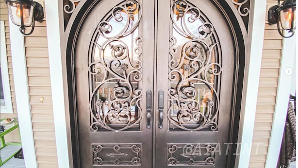A double door with intricate metalwork and two wall-mounted lanterns. - Bald Mountain House Inn at the Wolf Laurel Resort (Mars Hill)