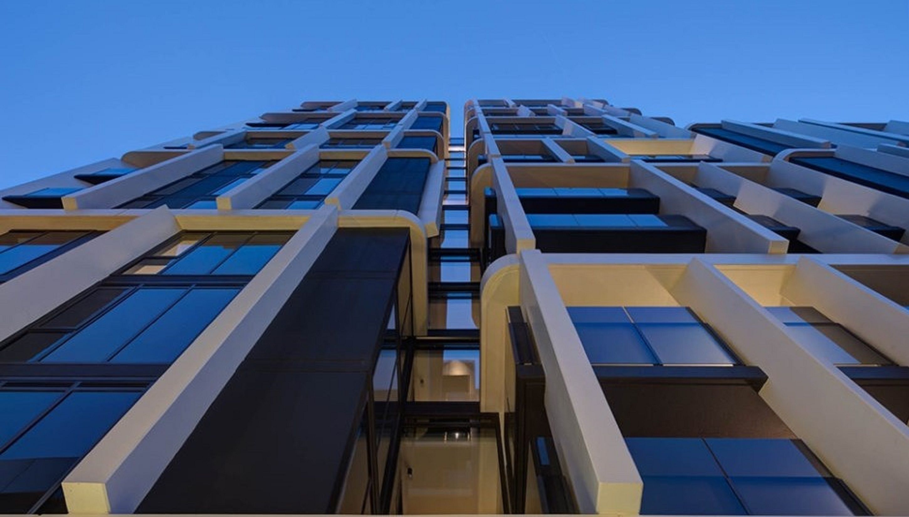 A high-rise building with multiple floors, large windows, and a modern architectural design.