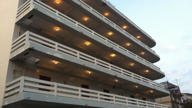 A multi-story building with balconies and a series of lights along the upper floors. - Sakol Hotel Korat (Nakhon Ratchasima)