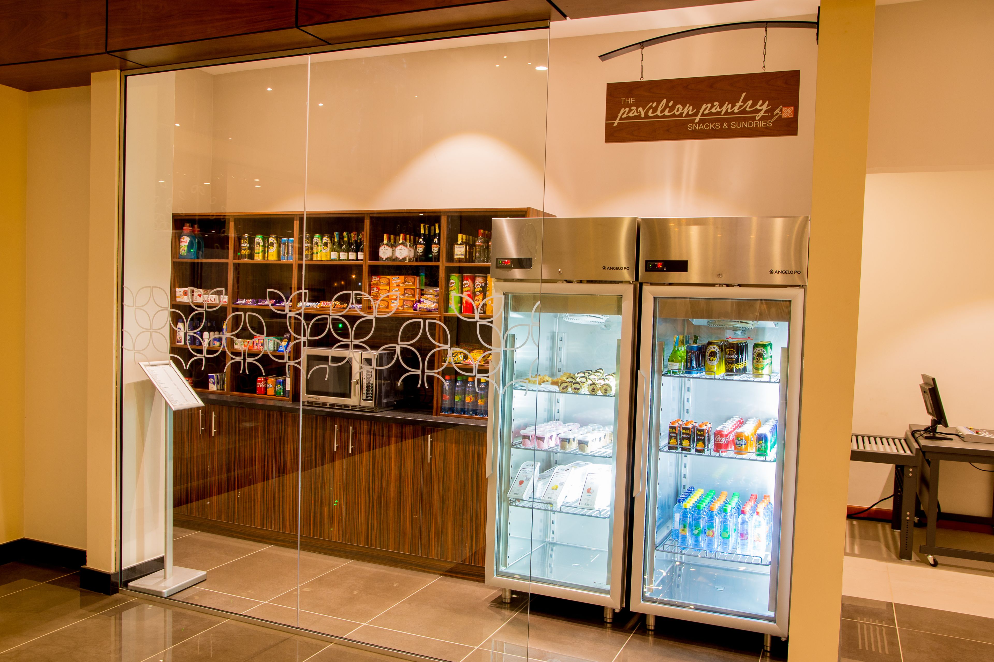 A snack and sundries section with refrigerated display cases and a variety of beverages.