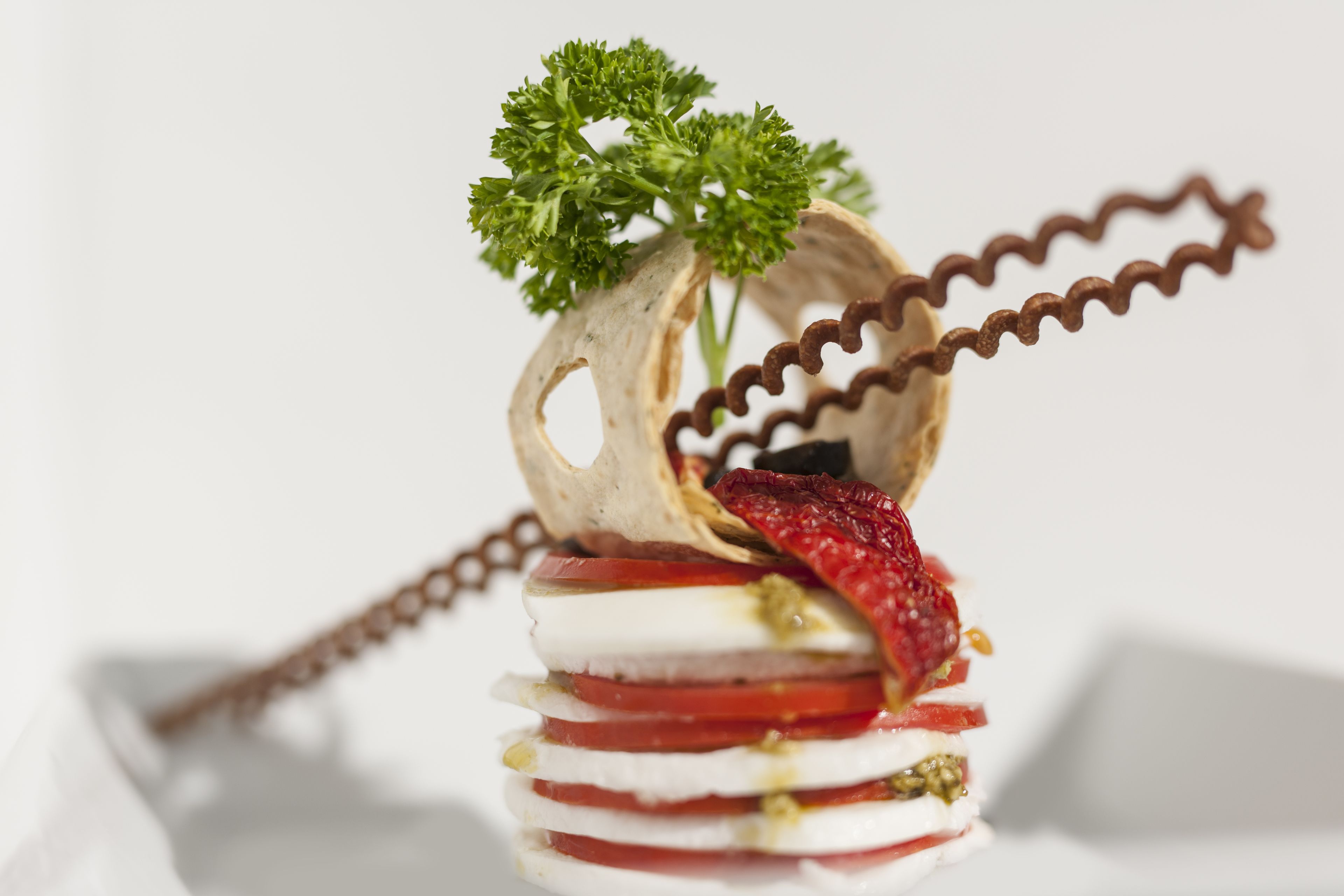 A layered food dish with a spiral structure and parsley garnish.