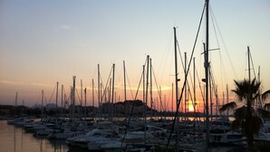 A marina at sunset with multiple sailboats docked. - Beautiful apartment near the beach with a view of the pool and the mountain 'Segaria' (El Verger)