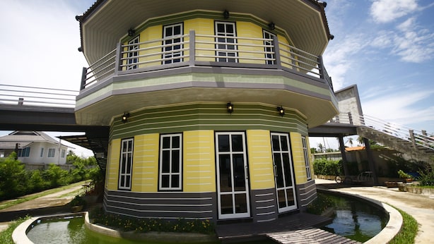 A multi-level house with a balcony, a small pool, and a bicycle parked nearby. - Wangthong Beach Resort (Laem Sing)
