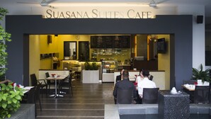 The interior of Suasana Suites Cafe with a bar area, seating, and a visible menu board. - AirPorter Bukit Bintang Residence (Kuala Lumpur)