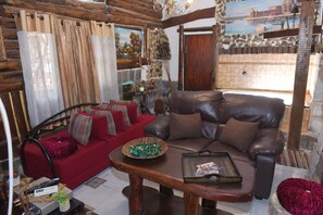 Traditional Suite, Jetted Tub | Living room | Flat-screen TV