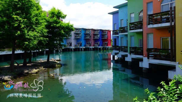 A riverside view with colorful buildings and a calm water body.