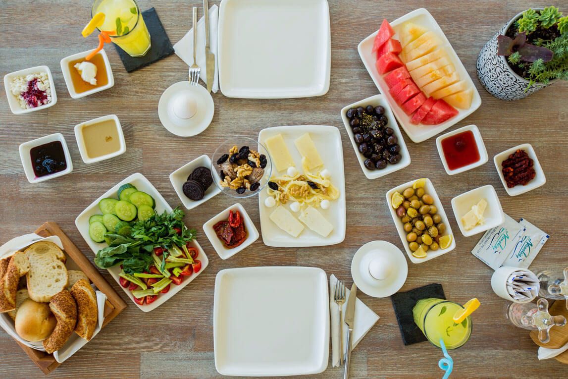 A breakfast buffet with various food items and drinks.