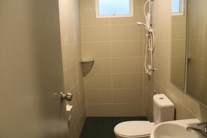 A small, compact bathroom with a toilet, sink, and shower. - Cozy Crib at 7 Tree Seven Residence (Cheras)