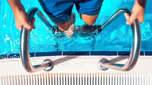 A person holding poolside handrails. - Kapya Cunda (Ayvalik)