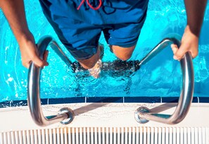 A person holding poolside handrails. - Kapya Cunda (Ayvalik)