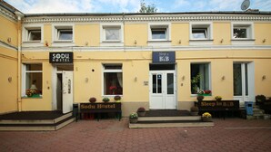 A hostel with a sign reading "SODU HOSTEL" and another sign for "Sleep in B&B". - Sleep In BnB (Vilnius)