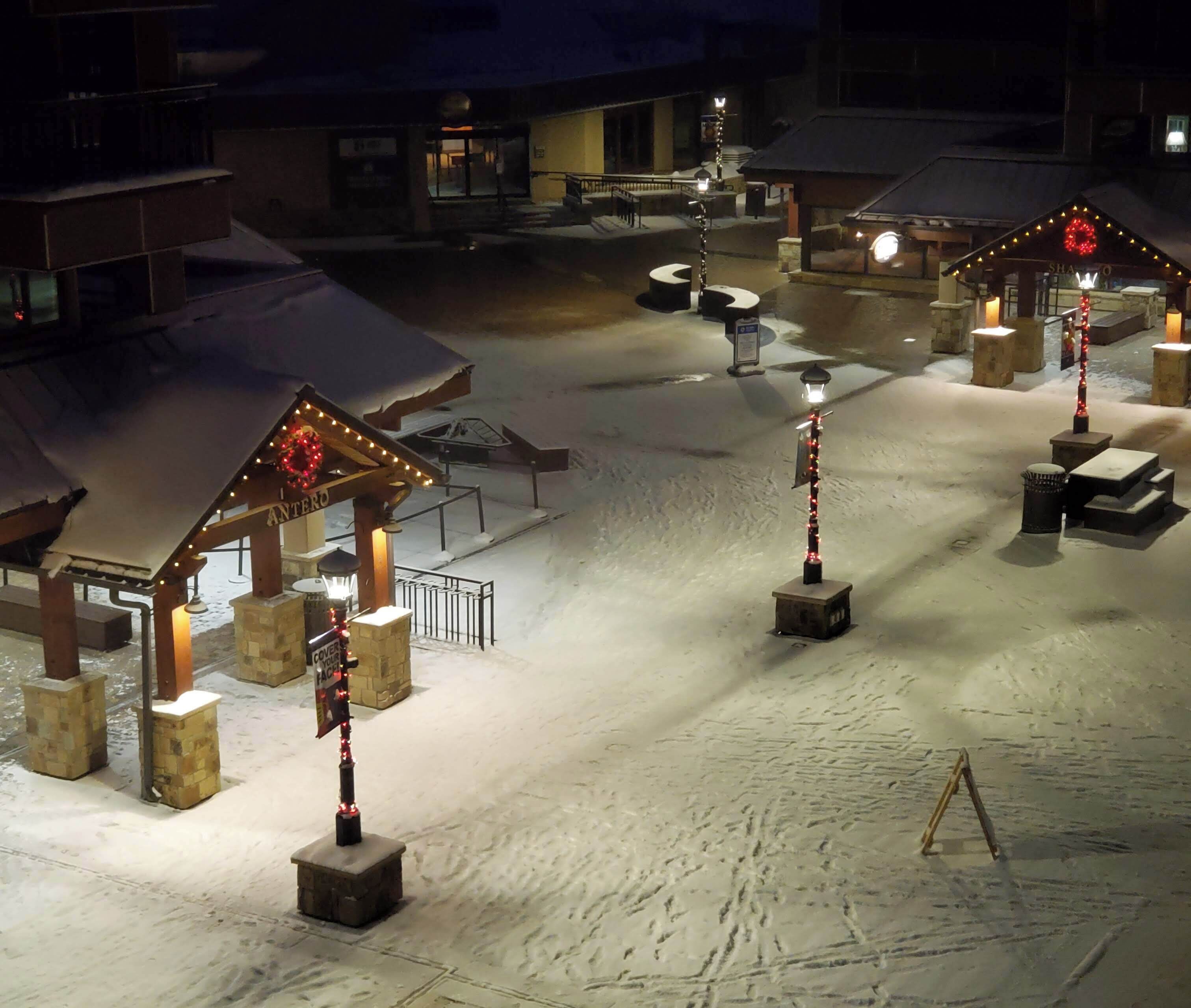 A snow-covered outdoor area with a covered seating area and a sign that reads "ANTERO."
