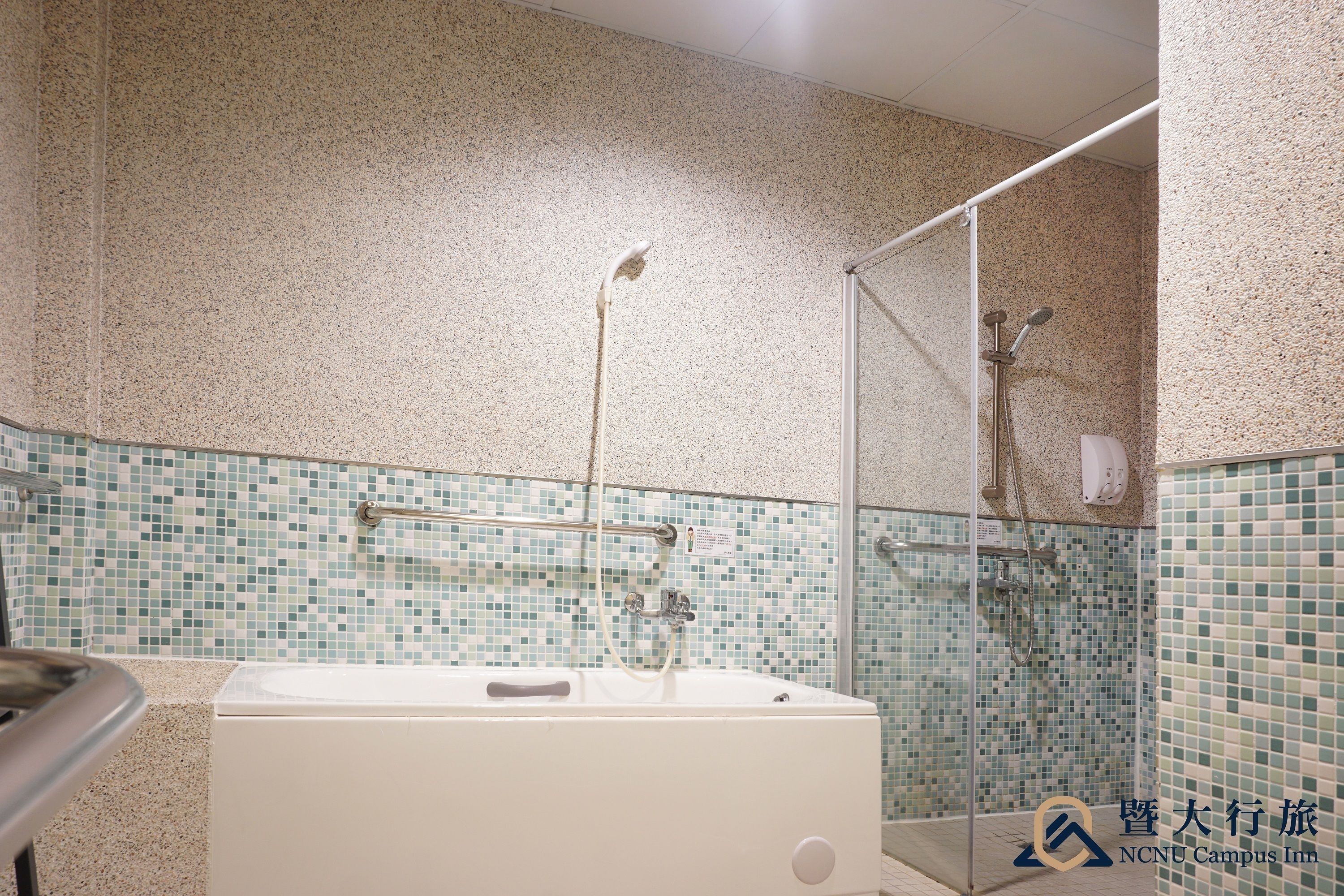 A bathroom with a bathtub, a shower, and a glass-enclosed shower area.