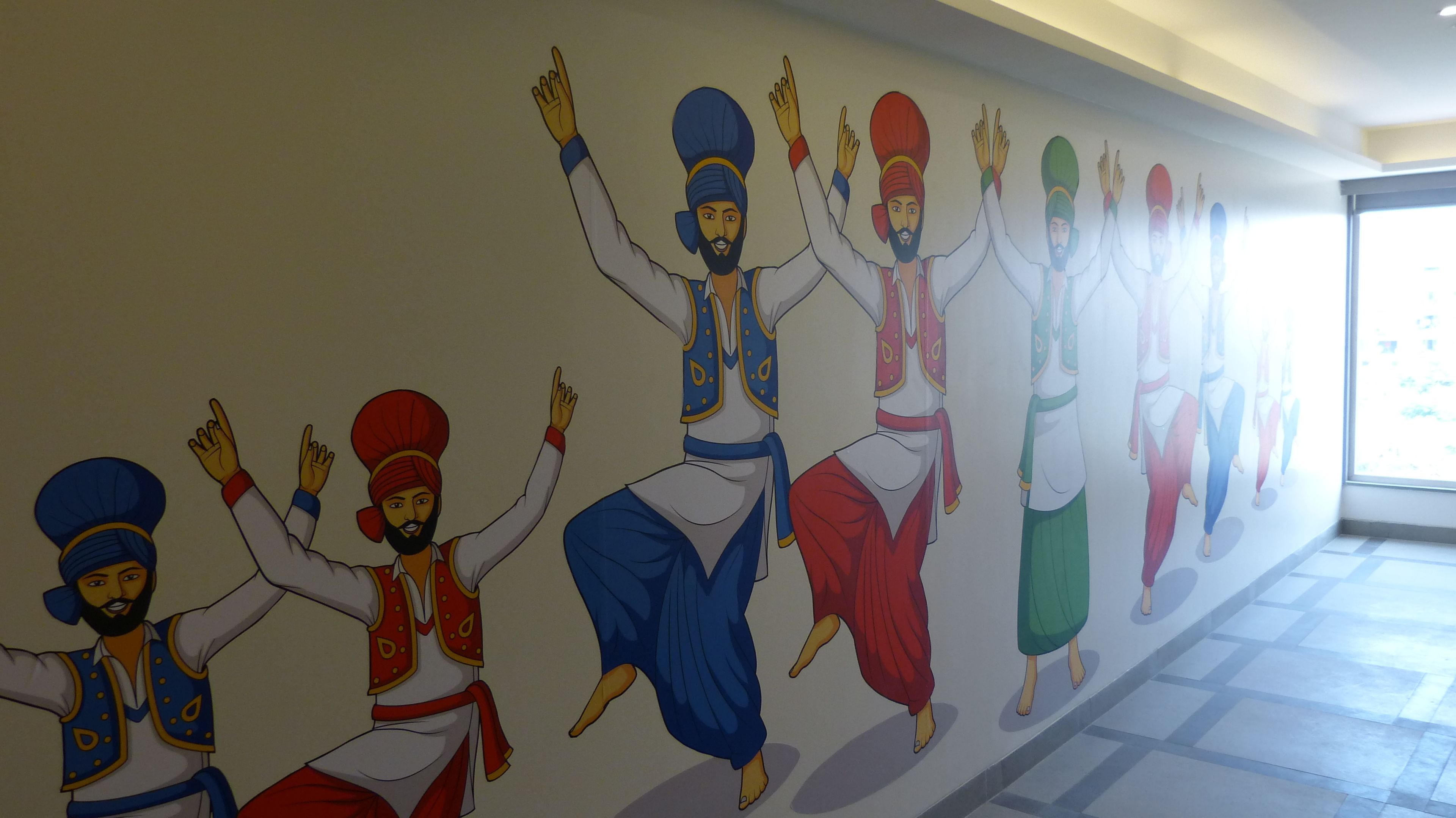 A mural of people in traditional attire on a wall.