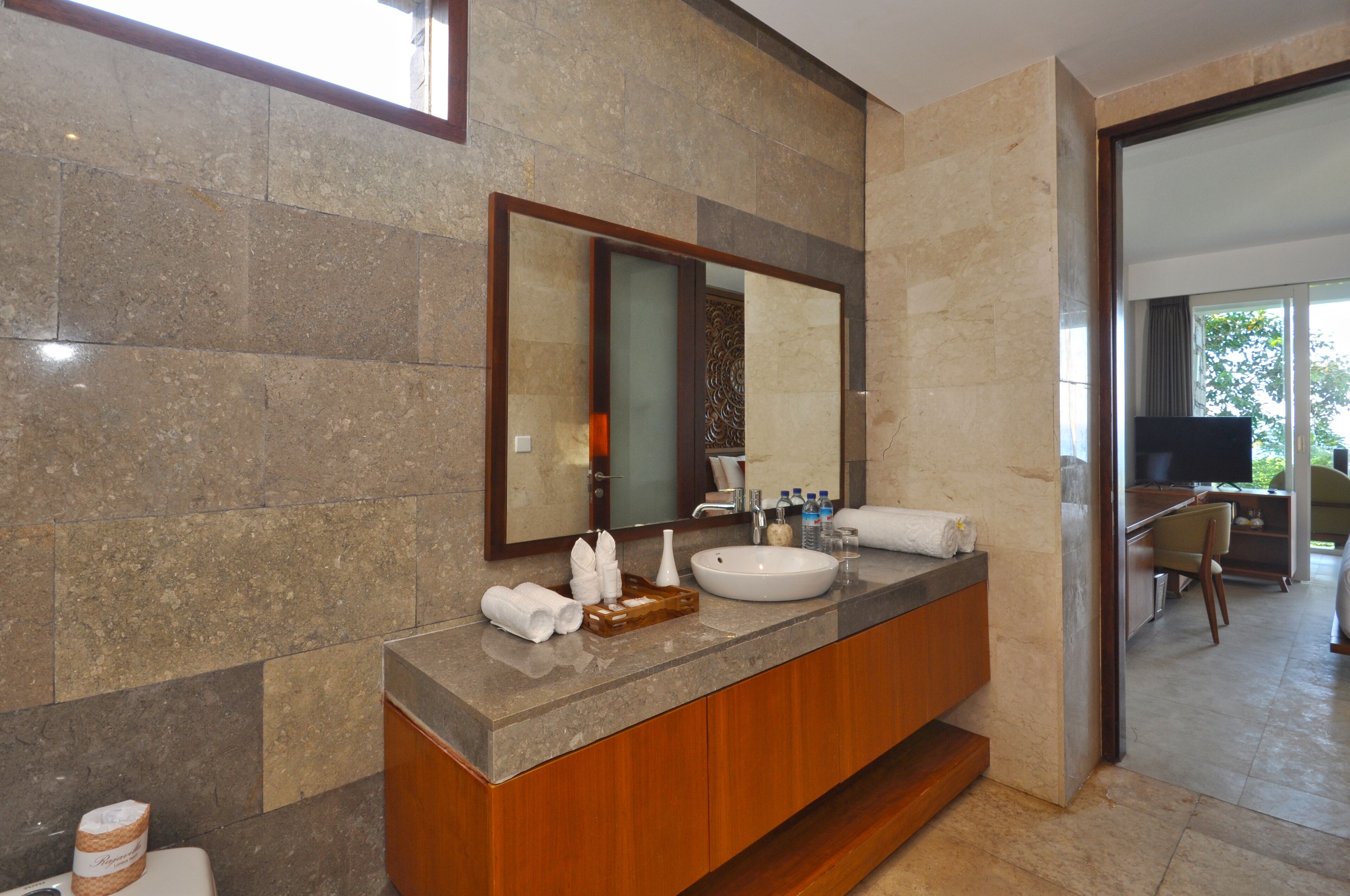 A modern bathroom with a large mirror, a sink, and a vanity.
