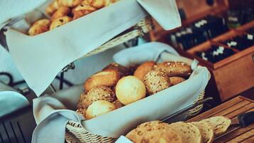 Two baskets of assorted bread and pastries.