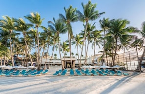 A beachside hotel with rows of sun loungers and palm trees. - Henann Crystal Sands Resort (Boracay Island)