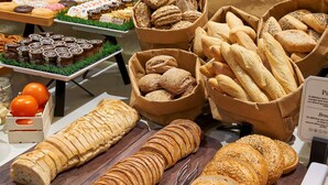 A variety of breads and pastries displayed on a table.