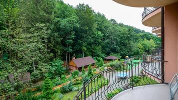 Enjoy a tranquil retreat with a garden view from the balcony, featuring a well-maintained garden area and a play structure.