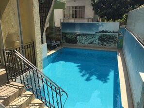 Seasonal outdoor pool, pool umbrellas, pool loungers