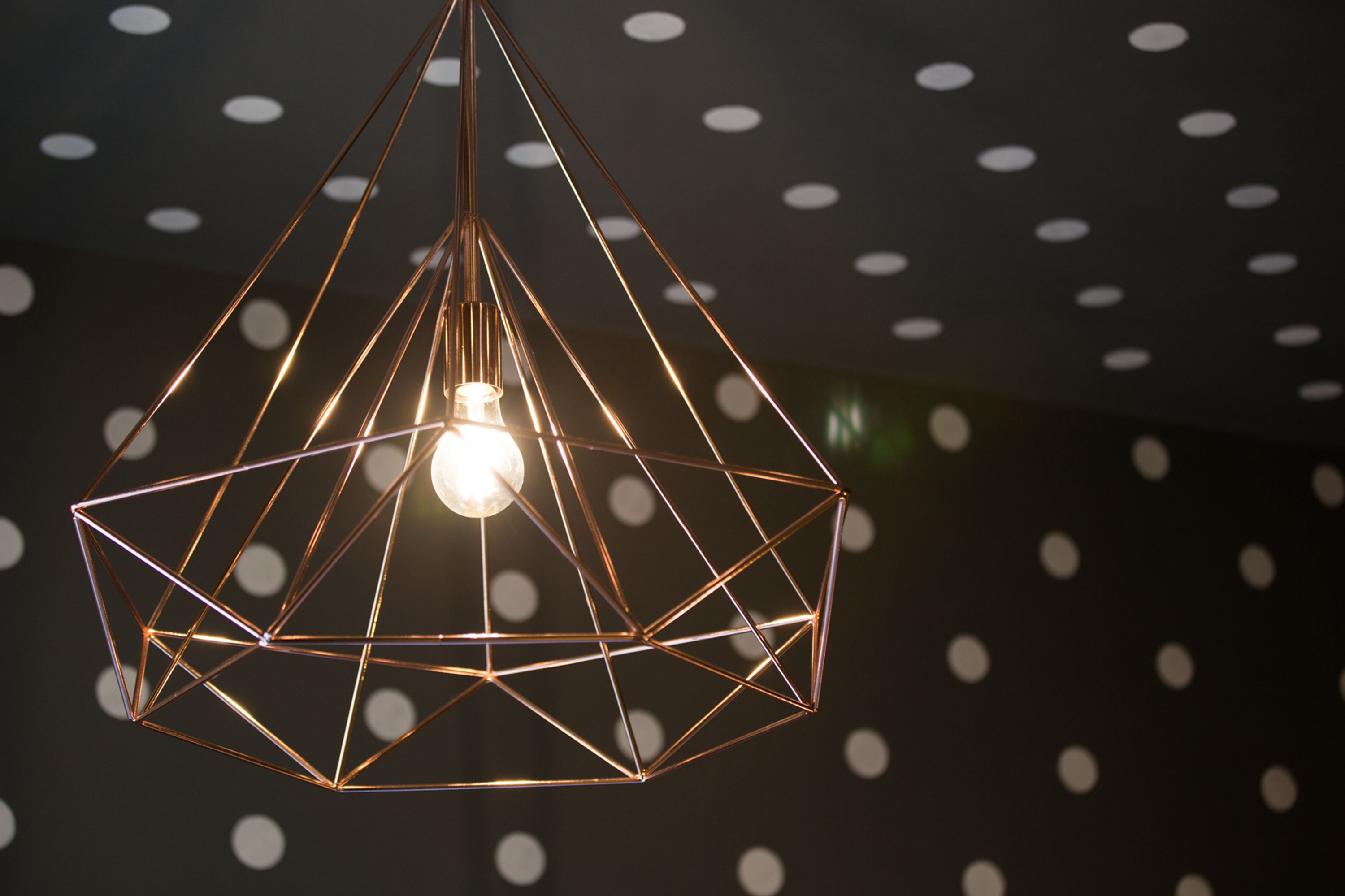 A geometric pendant light fixture with a visible bulb.
