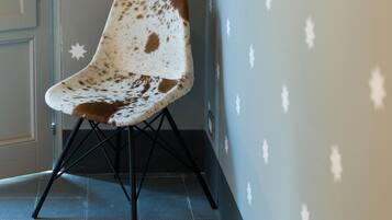 A chair with a unique design, positioned against a wall with star-shaped decorations.