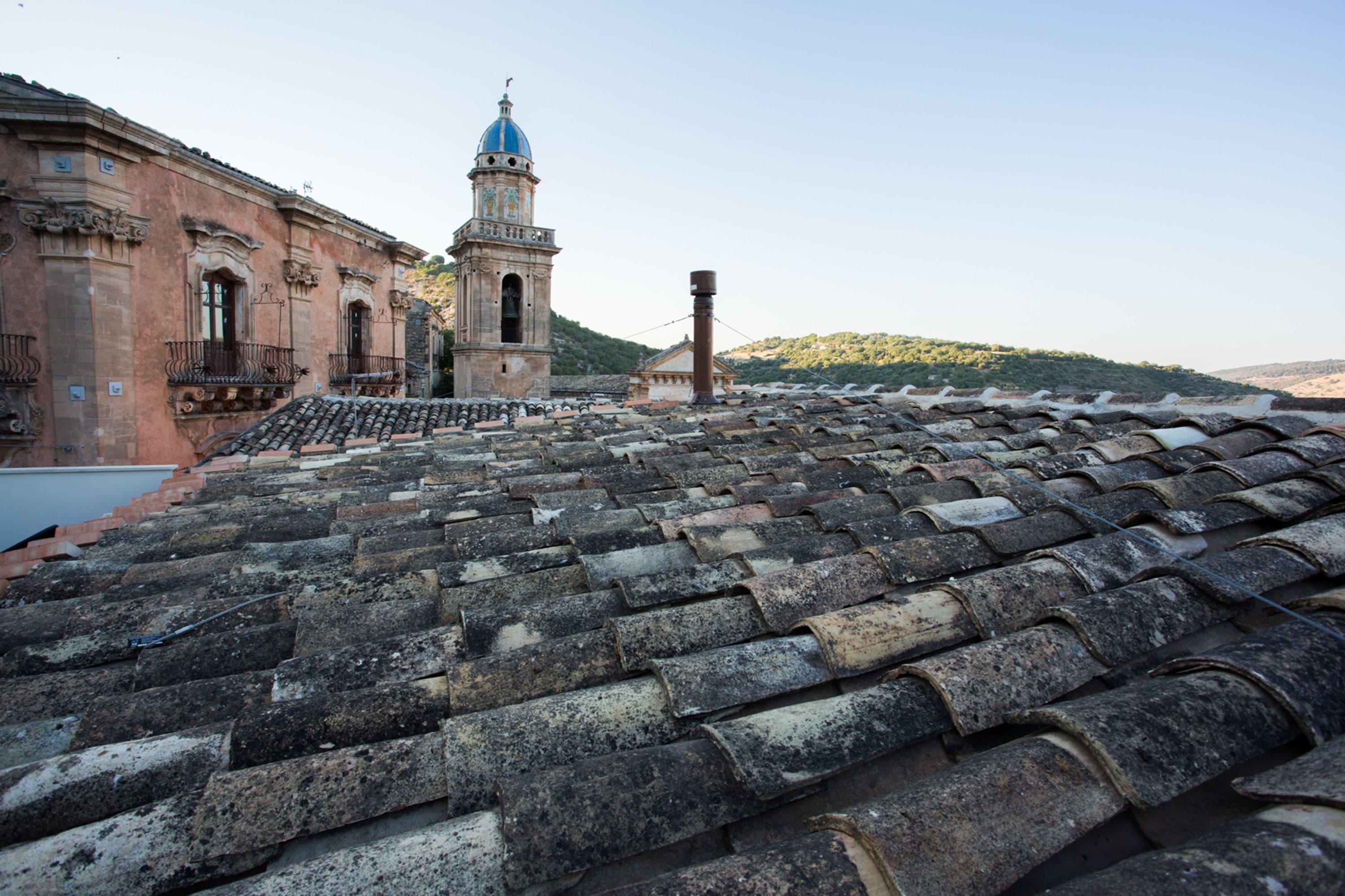 A historic building with a tiled roof and a bell tower.