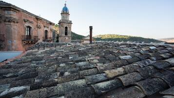 A historic building with a tiled roof and a bell tower.