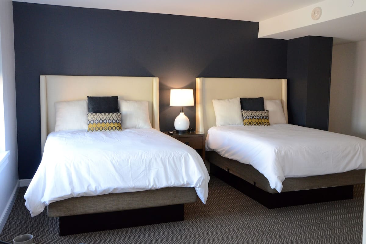 deluxe suite | premium bedding, desk, laptop workspace, iron/ironing board