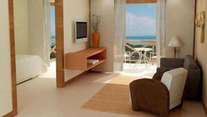 Una habitación de hotel moderna con balcón, televisión, sofá y zona de comedor.