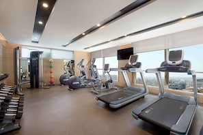 A modern gym with treadmills, elliptical machines, and free weights. - Hilton Garden Inn Al Khobar (Al Khobar)