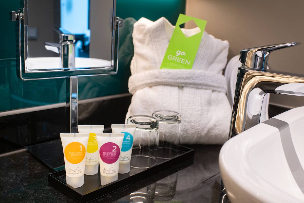 designer toiletries, hair dryer, towels