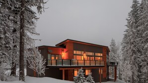 A modern two-story building with a balcony, surrounded by snow-covered trees. - Just completed 4 bedroom, 5 bathroom modern Town home, pool table, sleeps 10 (Golden)