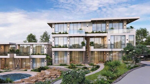 A modern multi-story residential building with a pool and landscaped garden. - GAIA Hotel & Residence Phu Quoc (Phu Quoc)