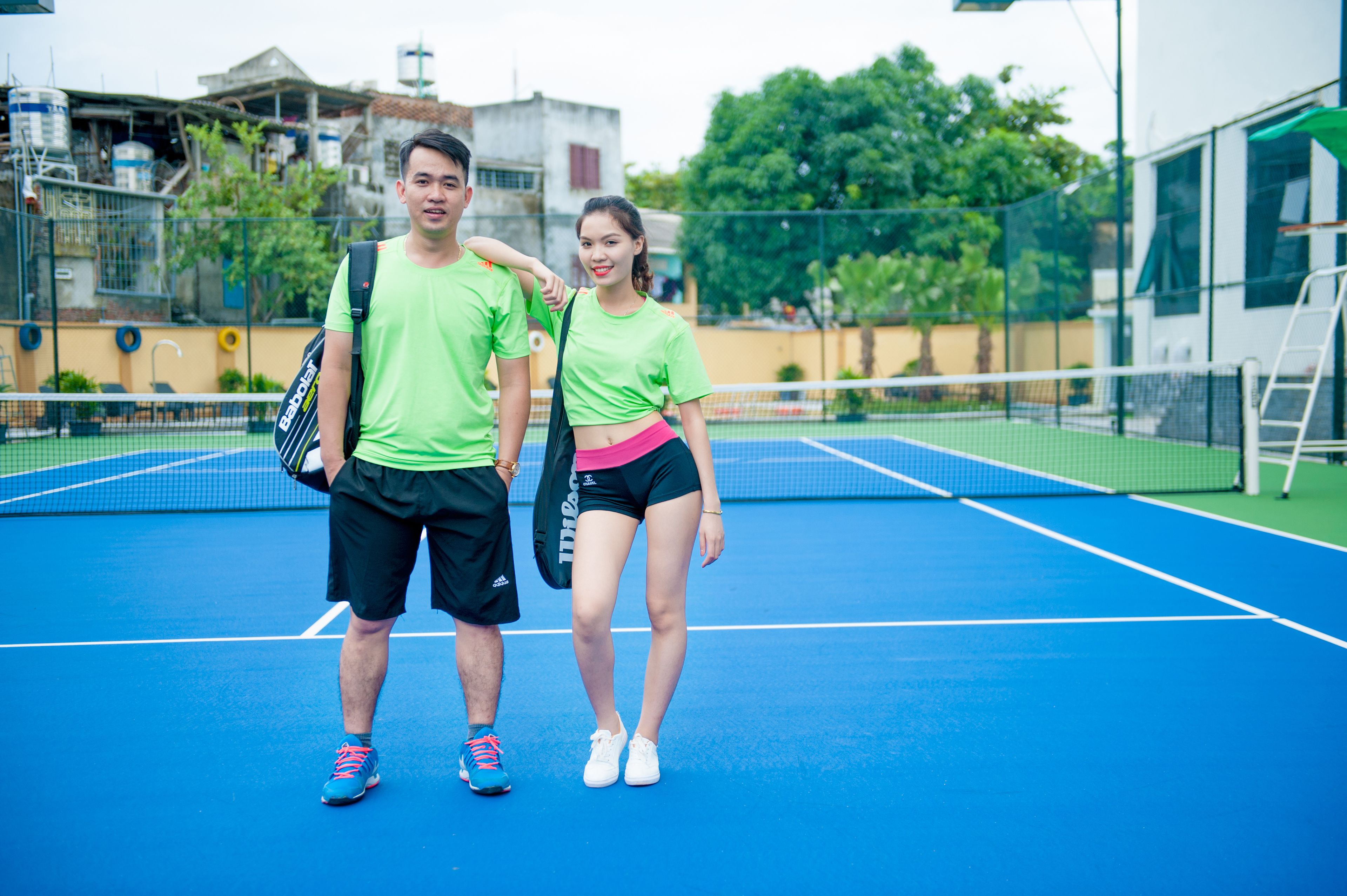 A tennis court with a net in the center, surrounded by a blue surface.