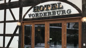 The entrance to Hotel Vorderburg with a traditional timber-framed facade and a large glass door. - Hotel Vorderburg (Schlitz)