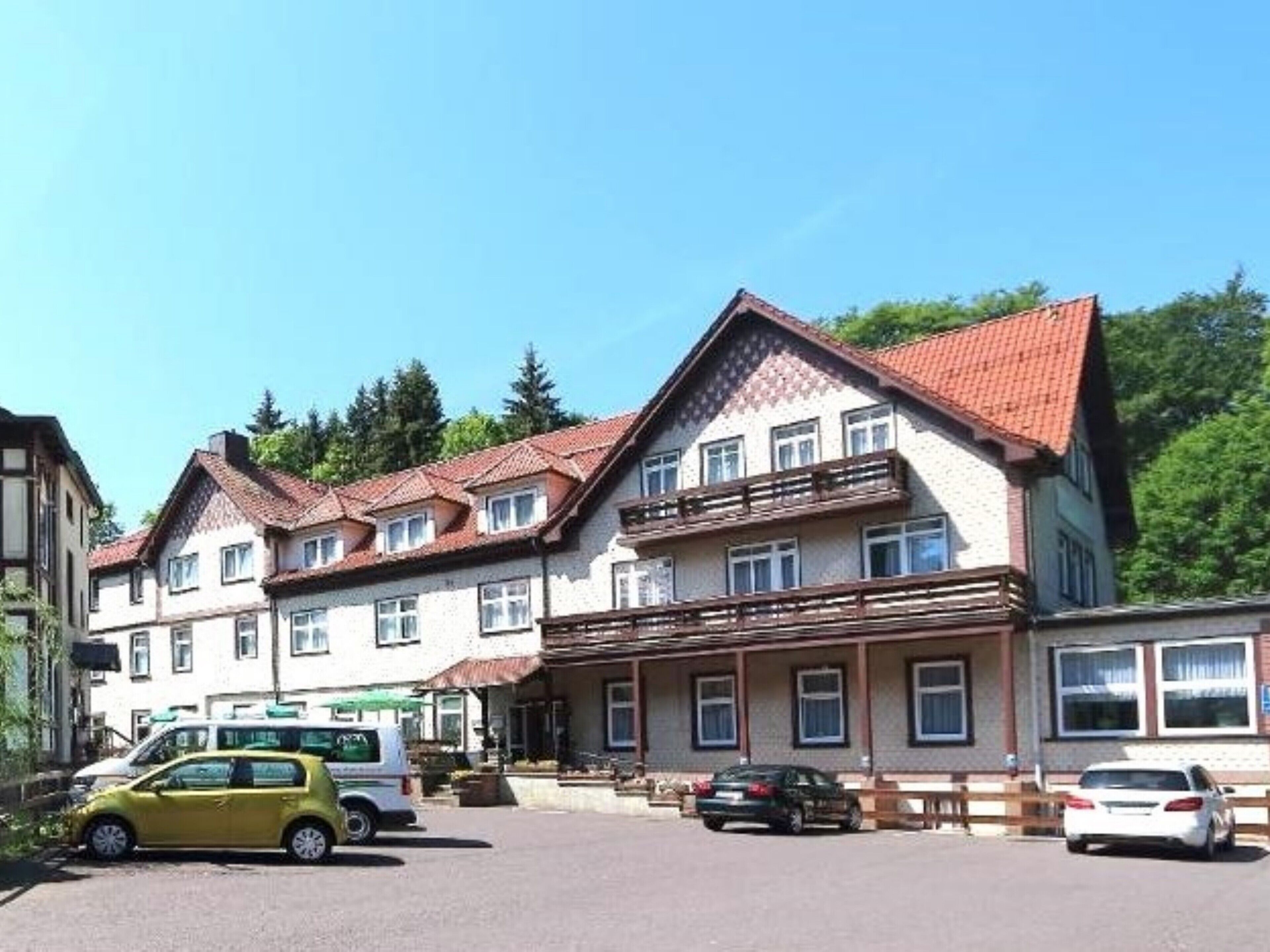A row of traditional European-style buildings with a central building featuring a balcony and multiple windows.