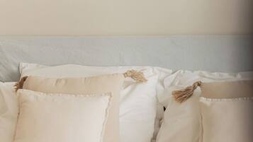 A bed with multiple pillows and a headboard.